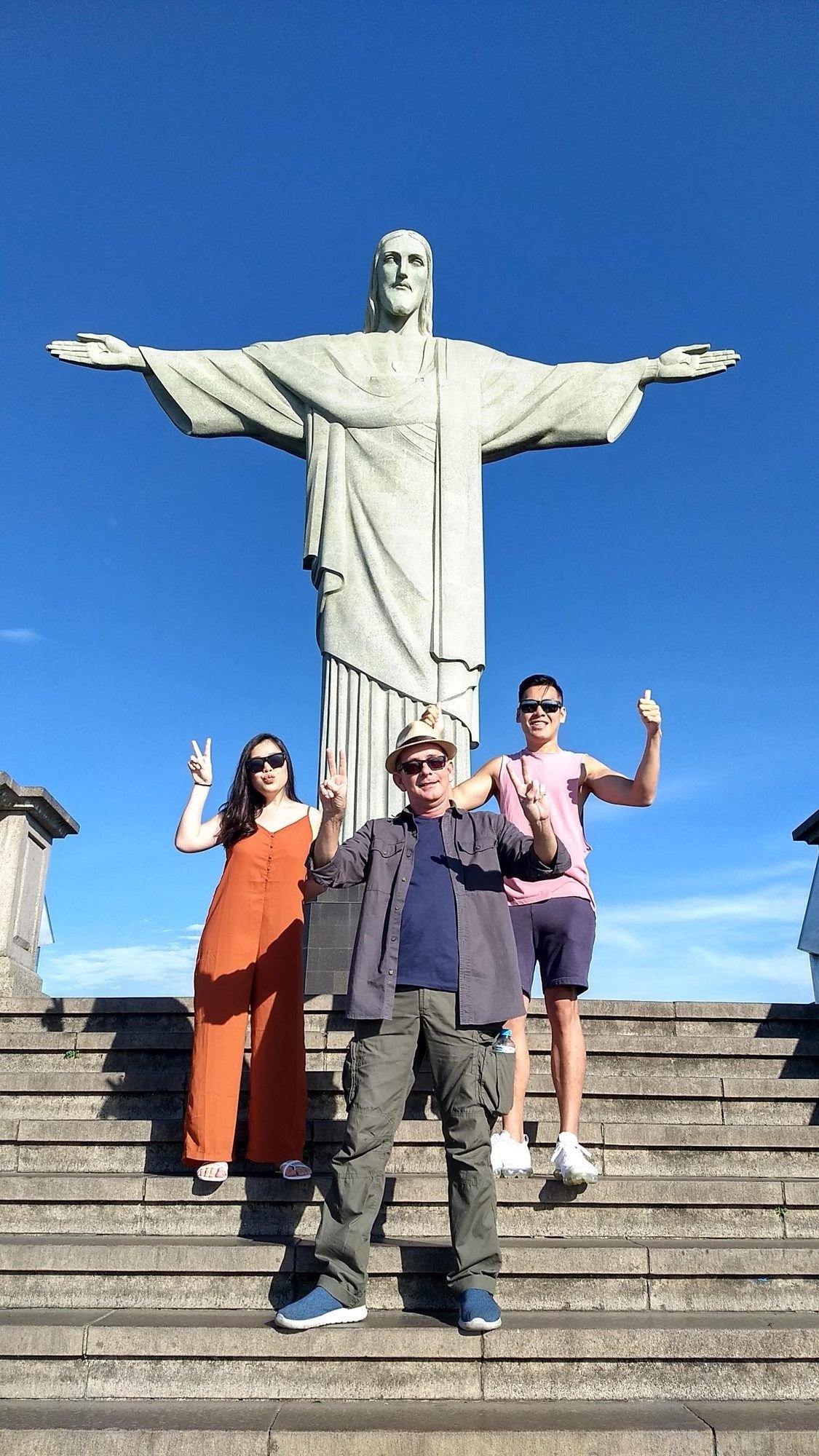 A family on the steps below Christ the Redeemer
