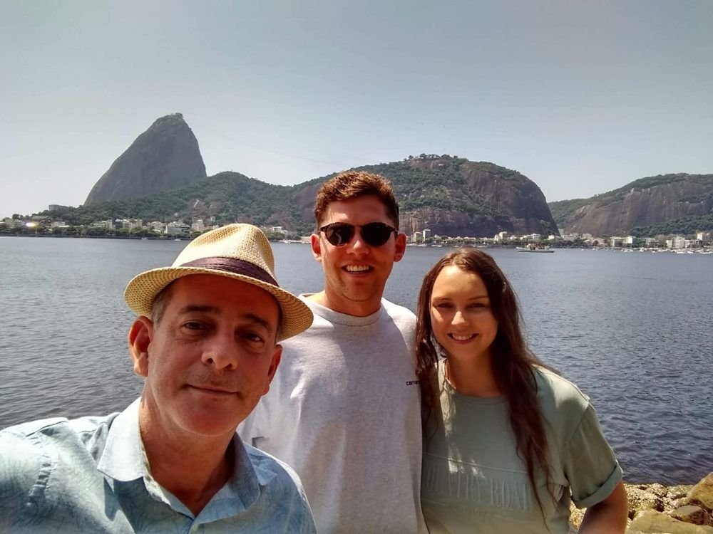 Marcio with guests on the water, Sugarloaf behind them