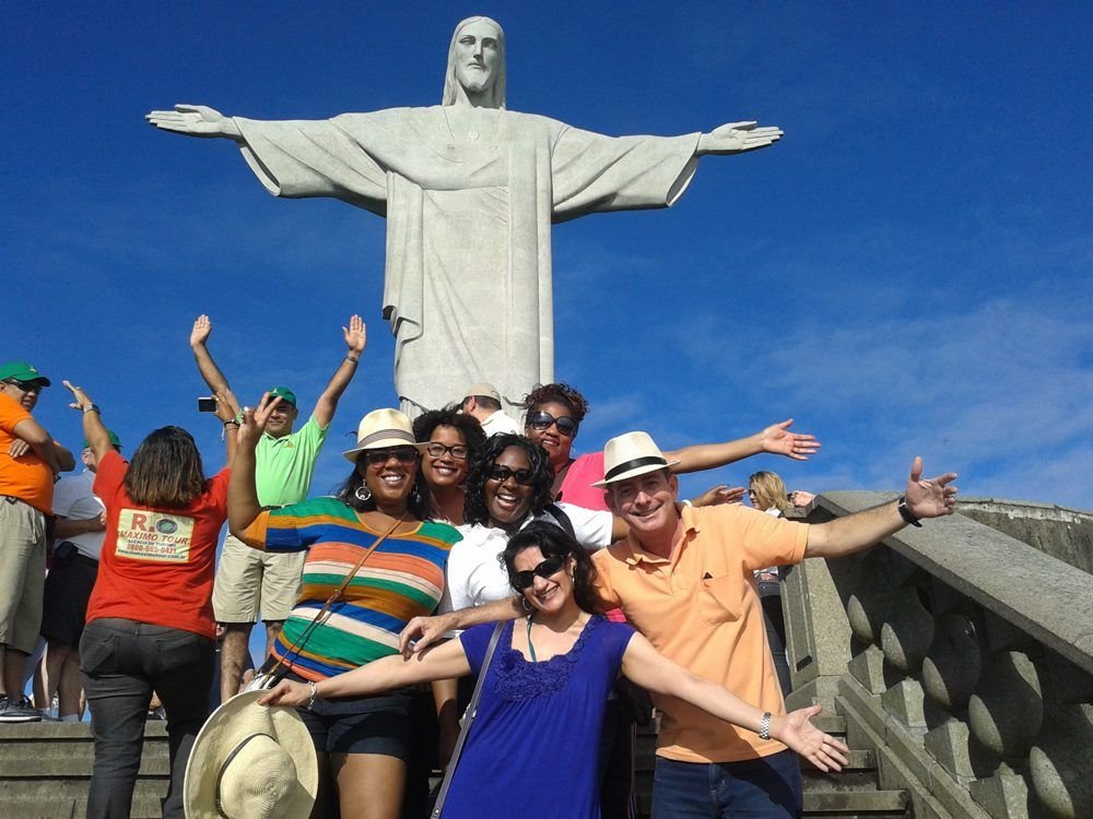 Travelers celebrating together at Christ the Redeemer